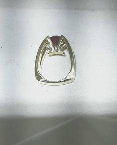 Eddie Sakamoto custom made 18k yellow gold ring. Set, suspended like, in a 4 prong head is an 2.75 carat red Rhodalite Garnet. The stone is a bright red. The 2 round diamonds are set in a tight prong style setting. The diamonds weigh .20 carat with Vs1 clarity and F-G color. A statement for sure. The band weighs 18.5 grams and is a size 8 Eddie Sakamoto is a well known Northwest designer. Unique Polished Moonstone Ring For Anniversary, Modern Formal Ruby Ring, Modern Ruby Promise Ring With Polished Finish, Opal Open Ring With Polished Finish For Anniversary, Anniversary Opal Open Ring With Polished Finish, Modern Hallmarked Red Rings, Modern 14k Gold Red Rings, Modern 14k Gold Opal Ring With Polished Finish, Modern Ruby Diamond Ring