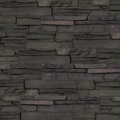 an image of a stone wall that looks like it is made out of black slate