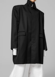 Color: Black Midweight woven cotton fabric Relaxed fit Pointed collar Padded shoulders Front flap pockets Concealed front button closure with placket Lined 100% Cotton Dry Clean Imported One Size Designer Black Outerwear With Concealed Front Fastening, Formal Cotton Outerwear With Flap Pockets, Modern Black Outerwear With Concealed Placket, Designer Black Outerwear With Concealed Placket, Black Oversized Outerwear With Welt Pockets, Oversized Black Outerwear With Welt Pockets, Office Cotton Outerwear With Concealed Placket, Modern Oversized Black Blazer, Black Blazer With Concealed Placket For Spring