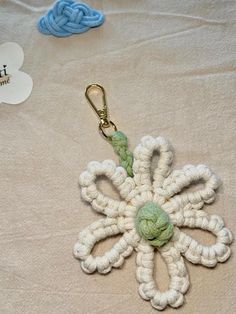 a crocheted keychain with a flower on it