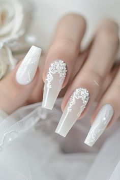 Step into elegance with these 38 white nail styles! Perfect for a clean, polished look, these nails feature everything from simple designs to elaborate art. Suitable for any event, these white nails will make your hands look effortlessly chic. Tap the link for more nail style inspiration! White Acrylic Wedding Nails, Christmas Bride Nails, Bridal Nails Long, Nails For A White Dress, Pearly White Wedding Nails, White Floral Wedding Nails, White Vine Nail Design, Wedding Nails Pearl White, Elegant White Nails