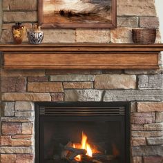 a fire place with a painting above it