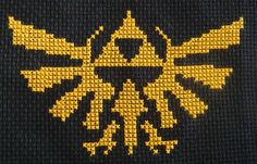 the legend of zelda cross stitched on to a black sweater with yellow accents