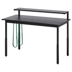 a black table with two green cords attached to it