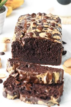 two pieces of chocolate cake sitting on top of a white plate next to each other