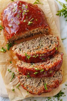 sliced meatloaf with marinara sauce and fresh herbs