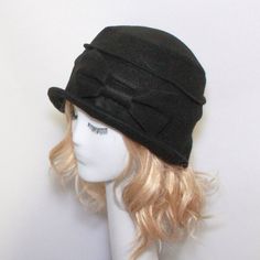 "Cloche Hat -Black Wool Felt- with raw edged bow, lined in black & white taffeta,the top is made up of 2 sections, a one piece brim and has a grosgrain ribbon band inside. One size fits all and will fit 21\" - 23\" head size. Regular Price: $65.00 SALE: $50.00 All of Bella Starr hats are made and designed from my original patterns. Caring for your hat: Dry clean only Bella Cloche can be folded for travel and all you need to do is steam or press to look good as new. Tip: If your hat is to big Wool Cloche Hat, Cloche Hats, Hat Stores, Stylish Hats, Cloche Hat, Felt Hat, Brim Hat, Winter Hat, Black Wool