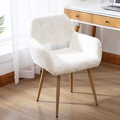 a white chair sitting on top of a hard wood floor next to a computer desk