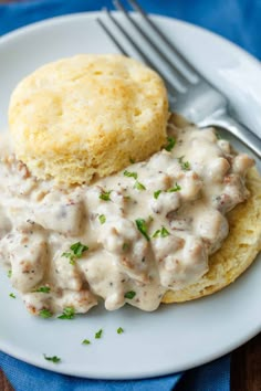 biscuits and gravy on a plate with a fork