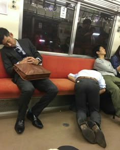 three people sleeping on a subway train seat