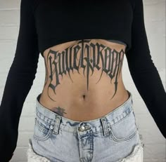 a woman with a tattoo on her stomach