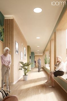 an older woman sitting on a bench in a hallway next to two women with canes