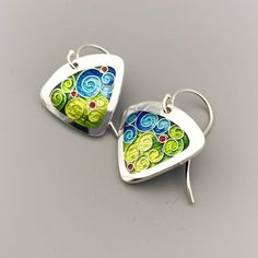 Green and Blue Swirls Triangle Dangle Earrings - cloisonne and champleve vitreous enamels-sterling silver earwires handmade by Sandra McEwenThese are simple, yet so stylish!  They would be a perfect complement to the Hummingbird necklace!Dimensions: 18mm x 36mmMaterials: Vitreous Enamels on fine silver.  Sterling silver ear wires.All my jewelry is handmade by me in my studio in beautiful North Carolina.  -------------------------------------------------------------------------------------------- Artsy Sterling Silver Jewelry With Artistic Design, Artsy Silver Teardrop Jewelry, Multicolor Enamel Jewelry With Ear Wire, Artsy Hand Painted Silver Earrings, Artistic Teardrop Enamel Jewelry, Artisan Enamel Jewelry With Ear Wire, Hand Painted Multicolor Sterling Silver Earrings, Green Hand Painted Sterling Silver Earrings, Green Enamel Earrings With Artistic Design