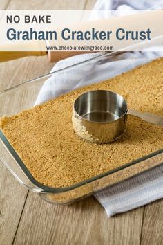 no bake graham cracker crust in a glass baking dish with a measuring spoon