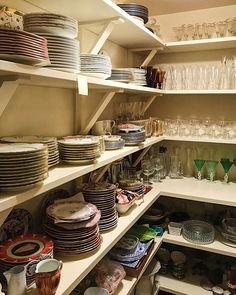 the shelves are filled with dishes and glasses