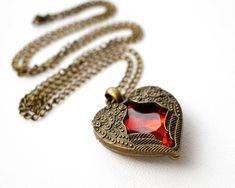 Get 15% off your order when you buy any 2 items in my shop! Vintage Jewelry, Red Heart Locket Necklace, Angel Wings, Red Crystal, Long Antiqued Bronze Chain, Love Gift, Christmas Gift for her This heart locket can't open, the red crystal is locked inside this ornate locket, with angel wings wrapping around the crystal. The necklace is from my private collection of 80s necklaces. It is in the perfect condition. More Fun Exciting Vintage Treasures here: http://www.etsy.com/shop/atVintage Vintage Red Jewelry With Heart Beads, Vintage Red Jewelry With Heart Charm, Red Necklace For Valentine's Day Anniversary, Red Necklace For Anniversary Gift On Valentine's Day, Vintage Red Necklace With Heart Charm, Red Heart Charm Necklace For Wedding, Vintage Red Heart-shaped Necklace, Valentine's Day Red Heart Necklace, Red Locket Necklace For Jewelry Making