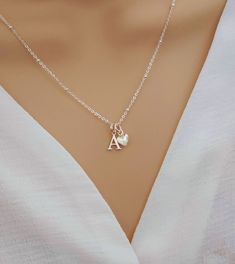 💖 Imagine the moment when you reveal this stunning initial & heart necklace... So pretty and absolutely gorgeous, she's sure to fall in love upon first glance!   💖 The most beautiful gift for yourself or someone special. Such a classy and elegant necklace she is sure to treasure forever. Delight her today with a precious and personalised gift.  Why Choose Our Initial & Heart Necklace? ✨ Elevate your style effortlessly ✨ A heartfelt gift that shows her how special she is ✨ Premium Quality Sterl Delicate Initial Pendant Necklace As Gift For Her, Delicate Initial Pendant Necklace For Her, Silver Minimalist Heart Pendant Initial Necklace, Minimalist Silver Heart Pendant Initial Necklace, Initial Pendant Charm Necklace As Gift For Her, Dainty Initial Pendant Charm Necklace For Her, Silver Initial Pendant Necklace For Mom, Elegant Initials Charm Necklace For Mom, Minimalist Sterling Silver Initial Necklace As Gift For Mom