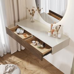 a white vanity with drawers and a large round mirror on the wall next to it