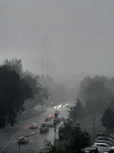 cars driving on a road in the rain