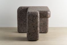 two stone stools sitting on top of a hard wood floor next to each other