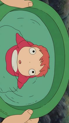 a cartoon character with red hair in a green circle surrounded by two hands and rocks