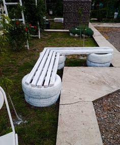 two white benches made out of old tires