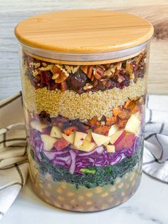 a glass jar filled with food sitting on top of a table