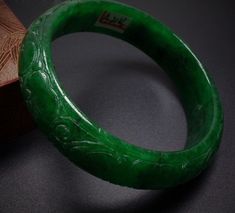 Vintage 59mm Hand-carved Green Jadeite Jade Bangle Bracelet #136 Size: 59 mm x 17mm x 9mm No certificate provided. Very nice condition. Want additional photos or have questions, just ask! Carved Jade Bangle Bracelet, Carved Jade Bangle As A Gift, Green Carved Bracelet As A Gift, Green Carved Bracelet For Gift, Green Carved Bracelets As Gift, Carved Green Jade Bangle, Green Carved Bangle Bracelet, Green Carved Bangle Bracelets, Green Carved Round Bangle