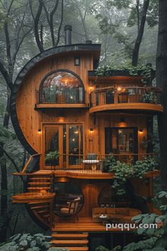 a house built into the side of a tree with stairs leading up to it's second story