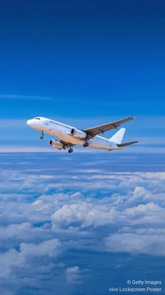 an airplane is flying high above the clouds