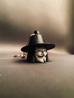 🎭 V for Vendetta Keychain 🎭 This keychain immortalizes the iconic mask and hat of V from the movie "V for Vendetta." The character is a memorable symbol known for his fight for freedom and justice. ### 🎁 Great Gift Option A perfect gift for fans of V for Vendetta! This keychain allows your loved ones to carry this legendary character with them always. Ideal for birthdays, anniversaries, or special occasions. ### 🚚 Fast Shipping and Secure Packaging Our products are carefully packaged and quickly shipped. Each keychain is placed in a gift box to prevent damage and then sent in a sturdy box for extra protection. This ensures it reaches you in perfect condition. ### ⚠ Attention This keychain is for collection purposes and should be handled with care due to its delicate nature. Keep it out V Pour Vendetta, Guy Fawkes Mask, V For Vendetta, Guy Fawkes, Collectible Figurines, The Movie, Sell On Etsy, First Love, How To Memorize Things