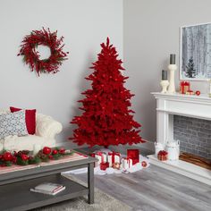 a living room decorated for christmas with red and white decorations on the fireplace mantel