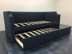 a blue couch with two pull out beds