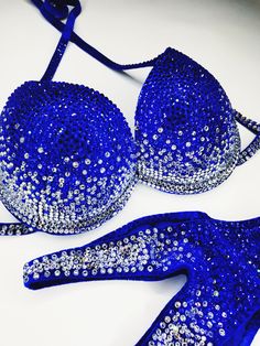 two blue bras with silver sequins on them