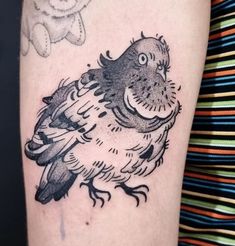 a black and white bird tattoo on the arm