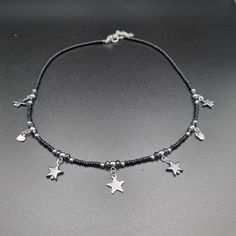 This elegant beaded necklace is made of glass beads in black, dark gray, and gray color, with various star and heart pendants. It can be worn for everyday occasions but is also suitable for special occasions. Necklace is 40 cm long, with a 5 cm extension chain. Elegant Beaded Necklace, Gray Beaded Necklace, Grey Beads, Heart Pendants, Necklace Elegant, Wedding Jewellery Necklace, Wedding Necklaces, Wedding Necklace, Beaded Necklaces