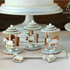 there is a cake that looks like a carousel with horses on the front and sides