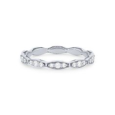 a white gold wedding band with round diamonds on the sides and wavy design, set in 18k white gold