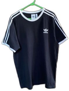 Classic Adidas Short Sleeve Tops, Classic Adidas Cotton Tops, Basic Adidas T-shirt With Three Stripes, Adidas Basic T-shirt With Three Stripes, Adidas Short Sleeve T-shirt With Three Stripes, Black Cotton T-shirt With Three Stripes, Black Cotton Tops With Three Stripes, Black Cotton Top With Three Stripes, Black Crew Neck T-shirt With Three Stripes