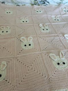 a crocheted blanket with rabbits on it