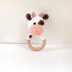 a crocheted giraffe head on a wooden ring