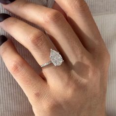 a woman's hand with a diamond ring on it