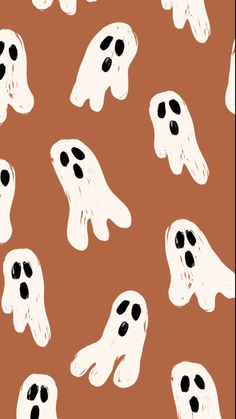 a brown background with white ghost faces on it