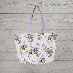 "Beautiful spring/summer purple and lavender floral print tote bag is perfect for women on the go who love the spring purple hues floral look! Tote bag can be folded easily into a suitcase for added convenience. Tote can be carried or wore on the shoulder. This multi-faceted bag can be used as a purse, to carry work supplies, used as a carry-on, travel bag, shopping, or for any event. Make-up bags, glasses, cell phone, and many other personal items can be placed in it securely. Tote would also m Purple Rectangular Bag For Summer, Casual Purple Shoulder Bag For Spring, Purple Summer Bags For Daily Use, Purple Summer Bag For Daily Use, Purple Bags For Everyday Use In Summer, Summer Purple Bag For Daily Use, Spring Purple Bag For Everyday Use, Purple Bags For Spring Travel, Purple Bags For Spring Season Gift