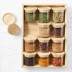 a wooden spice rack filled with lots of different spices