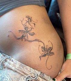 a woman's stomach with flowers on it and the bottom part of her belly