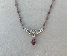 This dainty necklace is handmade using a 2mm genuine garnet rosary chain and a 18mm x 9mm heart connector with a 5mm garnet drop charm. A gold version is also available in my shop. This necklace is hypoallergenic. (Cadium free, lead free, and nickel safe) Garnet is an energizing stone that promotes passion and love.  The necklace comes in a ribbon-wrapped box, ready to be gifted. If you would like to leave a note for the recipient, you can do so during checkout. Garnet Rosary, Necklace With Charms, Jewelry Fancy, Etsy Jewellery, Edgy Jewelry, Crystal Necklaces, Rosary Necklace, Garnet Necklace, Nail Jewelry