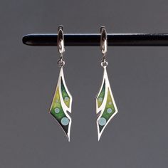 100% handmade sterling silver earrings, covered with hot cloisonné enamel. Cloisonné  is an ancient technique for decorating metalwork objects with colored material held in place or separated by metal strips or wire, normally of gold or silver. This process is quite laborious, because all the details require hand processing. Georgian cloisonné enamel counts more than 1200 years of history.  Our handmade pendants, earrings, brooches are vibrant with colour and compliment any outfit, prefered for daily wear or a special occasion. Materials: Sterling Silver, Fine Silver, Cloisonne enamel Earrings: Weight - 5.6 gr (approx) Drop Lenght - 3.6 cm; 1.4 inches  Lenght - 5 cm; 2 inches Width - 1.1 cm; 0.45 inches  Pendant; Weight - 2.5 gr (approx) Lenght -  3.6cm; 1.4 inches (without bail) Width - 1 Green Enamel Earrings With Artistic Design, Hand Painted Sterling Silver Dangle Jewelry, Green Hand Painted Sterling Silver Earrings, Artistic Silver Enamel Earrings, Artistic Enamel Jewelry With Matching Earrings, Artistic Enamel Drop Earrings, Artisan Green Enamel Earrings, Green Artisan Enamel Earrings, Artistic Enamel Jewelry With Earrings