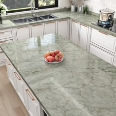 a bowl of fruit sitting on top of a kitchen counter