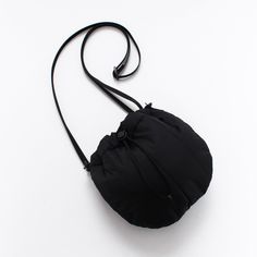 a small black bag sitting on top of a white table